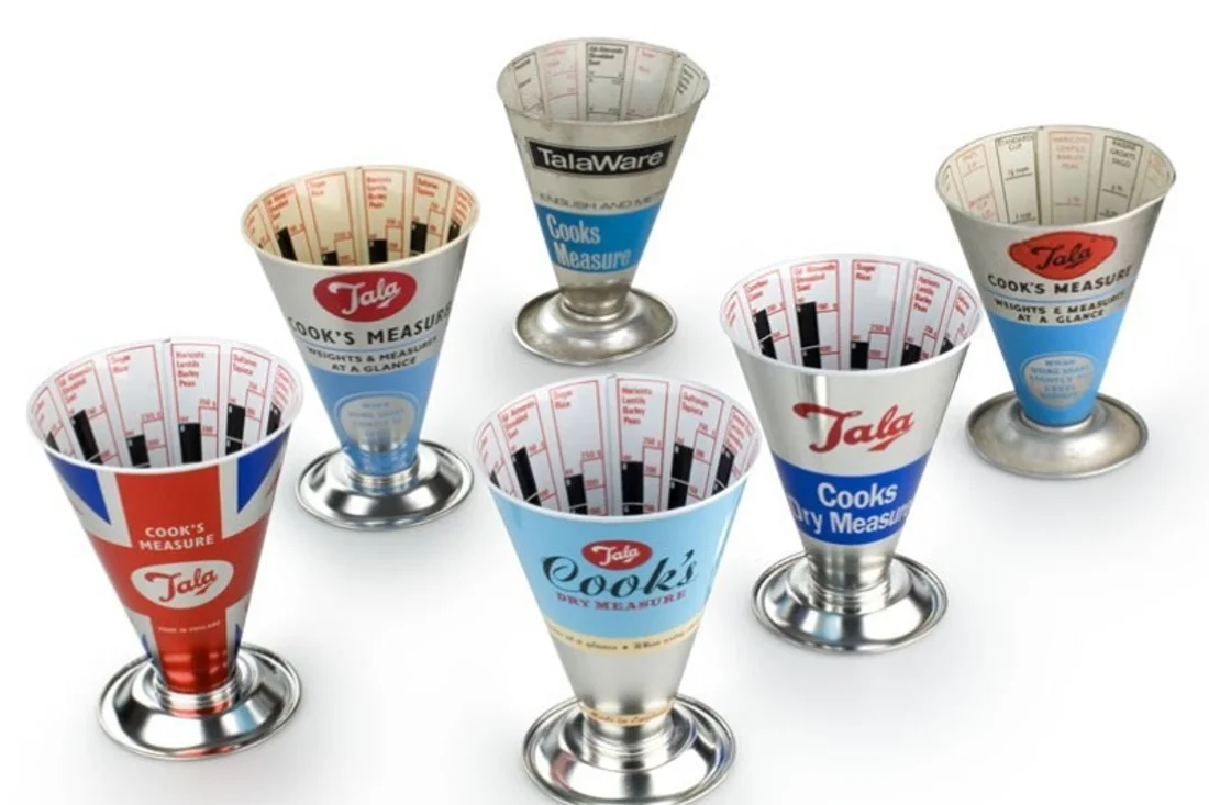 A set of six vintage Tala conical measuring cups, each printed with volume markings for measuring dry ingredients such as rice, lentils and sugar